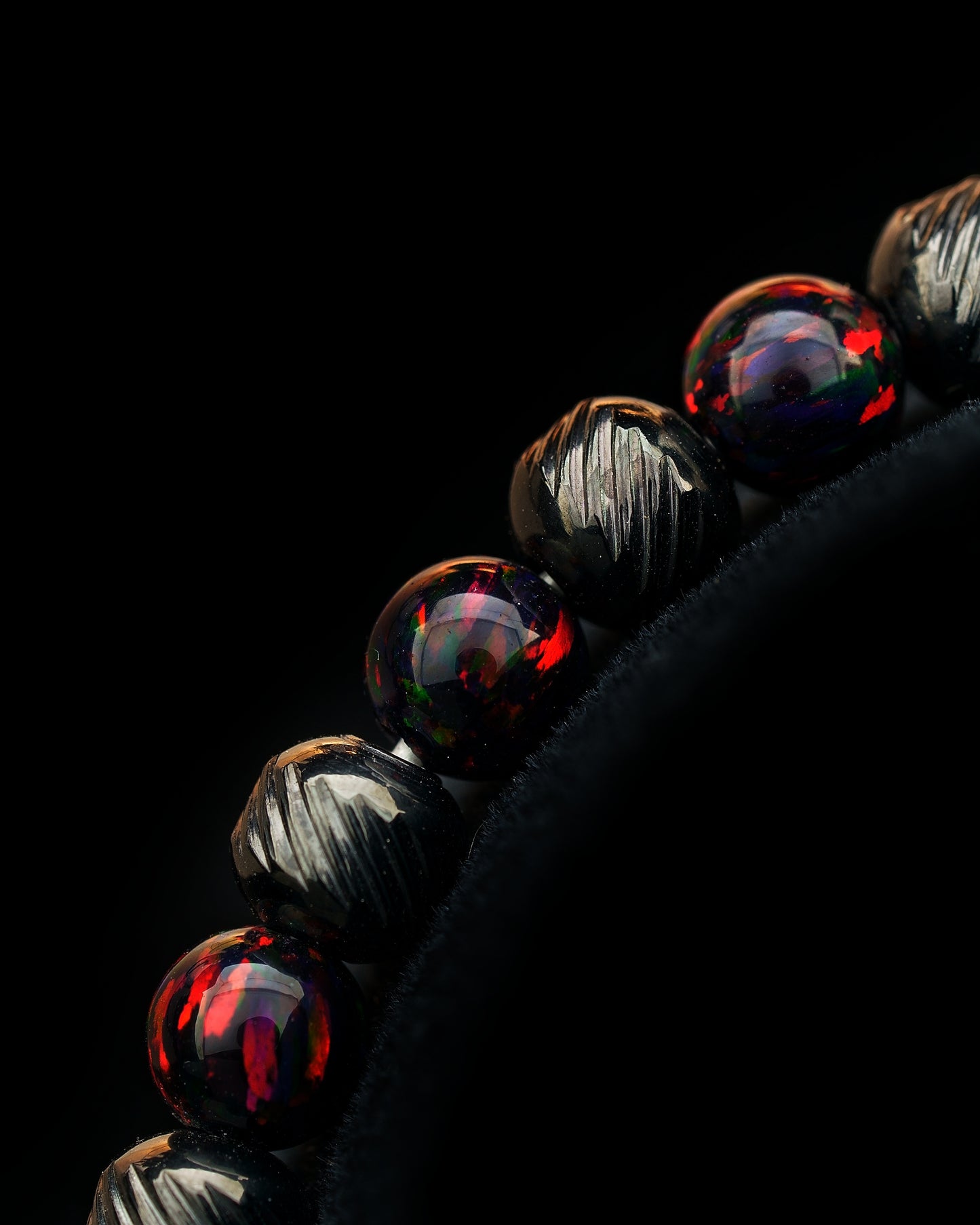 closer look on a stainless steel bracelet with genuine, dark red three dots gemstones, black oblique texture. different kind of closures, clasps 5/6mm, playable for men and women. Mudra chain classic every day jewelry.