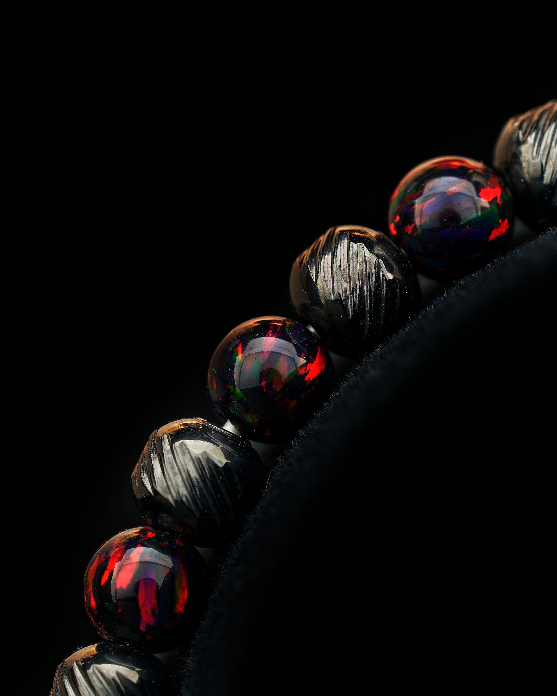 closer look on a stainless steel bracelet with genuine, dark red three dots gemstones, black oblique texture. different kind of closures, clasps 5/6mm, playable for men and women. Mudra chain classic every day jewelry.